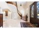 Elegant foyer featuring a curved staircase, marble floors, and decorative ironwork at 237 Wilson Lake Rd, Mooresville, NC 28117