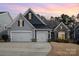 Two-story home with gray and dark siding, two-car garage, and landscaping at 245 Sweet Briar Dr, Fort Mill, SC 29707