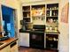 Galley kitchen with wood cabinets and black appliances at 309 York Rd, Kings Mountain, NC 28086