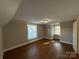 Hardwood floors and multiple windows in this bedroom at 330 E Main St, Albemarle, NC 28001