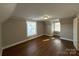 An attic bedroom offers a cozy and private retreat with hardwood floors at 330 E Main St, Albemarle, NC 28001