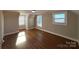 Spacious bedroom with hardwood floors and multiple windows at 330 E Main St, Albemarle, NC 28001