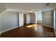 An attic bedroom offers a cozy retreat with hardwood floors and natural light at 330 E Main St, Albemarle, NC 28001