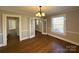 Dining room featuring hardwood floors, chandelier, and natural light at 330 E Main St, Albemarle, NC 28001