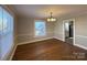 Dining room featuring hardwood floors, chandelier, and natural light at 330 E Main St, Albemarle, NC 28001