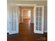 Hardwood floor hallway with french doors leading to other rooms at 330 E Main St, Albemarle, NC 28001