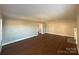 Bright living room with hardwood floors and access to other rooms at 330 E Main St, Albemarle, NC 28001