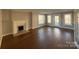 Living room with hardwood floors, fireplace, and access to the patio at 330 E Main St, Albemarle, NC 28001