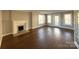 Bright living room featuring hardwood floors, fireplace, and natural light at 330 E Main St, Albemarle, NC 28001