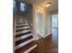 Staircase with hardwood steps and white railing at 330 E Main St, Albemarle, NC 28001