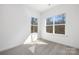 Well-lit bedroom featuring neutral carpeting and large windows at 3739 Kennedy Rd, Gastonia, NC 28056