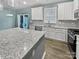 Modern kitchen with white cabinets, granite counters, and stainless steel appliances at 3758 Yorkshire Pl, Terrell, NC 28682