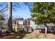 View of backyard featuring a deck, dog house, and mature trees at 413 W 5Th Ave, Gastonia, NC 28052