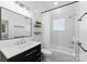 Bathroom featuring a shower-tub combo, black vanity, and patterned tile floor at 413 W 5Th Ave, Gastonia, NC 28052