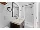 Bathroom with white tile shower, dark vanity with white sink, and black accents at 413 W 5Th Ave, Gastonia, NC 28052