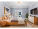 Serene bedroom with light blue walls, a comfortable bed, and ample natural light from the window at 413 W 5Th Ave, Gastonia, NC 28052