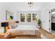 Bright bedroom featuring a large window, light-colored walls, and a comfortable bed with stylish decor at 413 W 5Th Ave, Gastonia, NC 28052