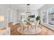 Elegant dining room with a round glass table, stylish white chairs, and a modern light fixture at 413 W 5Th Ave, Gastonia, NC 28052