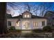 Charming two-story home with white siding, a welcoming front porch, and the American flag on display at 413 W 5Th Ave, Gastonia, NC 28052