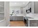 Beautiful kitchen with stainless steel appliances, gray cabinets, and wood flooring at 413 W 5Th Ave, Gastonia, NC 28052