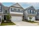 Modern townhome with a two-car garage, stone accents, white siding, and dark shutters for a sleek and contemporary look at 4134 Steel Way, Sherrills Ford, NC 28673