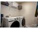 Bright laundry room, featuring Samsung washer and dryer, and ample shelving at 4134 Steel Way, Sherrills Ford, NC 28673