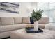 Cozy living room featuring a comfortable beige sofa, stylish decor, and bright natural light from the window at 4134 Steel Way, Sherrills Ford, NC 28673