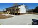 View of home's front and side with new concrete driveway and light wood porch at 4262 Williamson Rd, Rock Hill, SC 29730