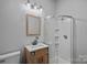 Modern bathroom features a glass enclosed shower, wood vanity, and stylish fixtures at 4747 Kenneths Dr, Maiden, NC 28650