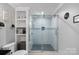 Bright bathroom featuring a glass-enclosed shower and open shelving for storage and decor at 4747 Kenneths Dr, Maiden, NC 28650