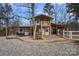 Charming two-story farmhouse with a wooden staircase leading to a balcony and a spacious covered patio at 4747 Kenneths Dr, Maiden, NC 28650