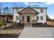 Charming two-story home with black and white design, wood accents, and a welcoming front porch at 4747 Kenneths Dr, Maiden, NC 28650