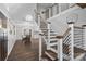 Modern staircase with wood steps and metal railings leading to an open-concept dining area at 4747 Kenneths Dr, Maiden, NC 28650