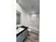 Modern bathroom featuring a framed mirror, gray vanity, and shower over tub with white subway tile at 507 E Lackey Farm Rd, Stony Point, NC 28678