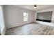 Bright bedroom with wood floors, a ceiling fan, and a modern accent wall with built-in shelving at 507 E Lackey Farm Rd, Stony Point, NC 28678