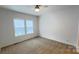 Bedroom with plush carpeting, a ceiling fan, and natural light from a window at 507 E Lackey Farm Rd, Stony Point, NC 28678