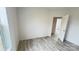 Bright bedroom featuring wood-look flooring and natural light from a window and closet at 507 E Lackey Farm Rd, Stony Point, NC 28678