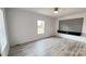 This spacious bedroom boasts gray wood flooring, a ceiling fan and large windows with natural light at 507 E Lackey Farm Rd, Stony Point, NC 28678