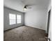 This bedroom features carpet, neutral paint, a ceiling fan, and two windows for natural light at 507 E Lackey Farm Rd, Stony Point, NC 28678