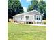 Charming single-story home boasts a well-manicured lawn and classic architectural details at 507 E Lackey Farm Rd, Stony Point, NC 28678