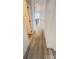 Hallway with wood flooring, white walls, and doors, connecting the home's interior spaces at 507 E Lackey Farm Rd, Stony Point, NC 28678