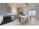 Bright kitchen featuring gray cabinets, stainless steel appliances, a large island, and modern light fixtures at 507 E Lackey Farm Rd, Stony Point, NC 28678