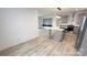 Spacious open-concept living room with wood-look flooring, flows into a modern kitchen with gray cabinets at 507 E Lackey Farm Rd, Stony Point, NC 28678