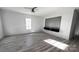 Bright living room with wood-look flooring, ceiling fan, a window, and a decorative accent wall at 507 E Lackey Farm Rd, Stony Point, NC 28678