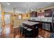 Kitchen with dark wood cabinets, granite counters, and island at 5124 Stone Park Dr, Charlotte, NC 28269