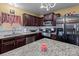 Spacious kitchen with granite countertops, stainless steel appliances, and dark wood cabinets at 5124 Stone Park Dr, Charlotte, NC 28269