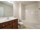 Clean bathroom with a tub, shower, and wood vanity at 6340 Revolutionary Trl, Charlotte, NC 28217