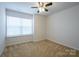 Well-lit bedroom with large window and ceiling fan at 6340 Revolutionary Trl, Charlotte, NC 28217