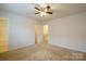 Bedroom with ceiling fan and access to hallway and bathroom at 6340 Revolutionary Trl, Charlotte, NC 28217