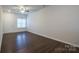 Living room with hardwood floors, neutral walls and door access at 6340 Revolutionary Trl, Charlotte, NC 28217